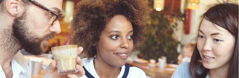 Two women and a man are having a conversation.
